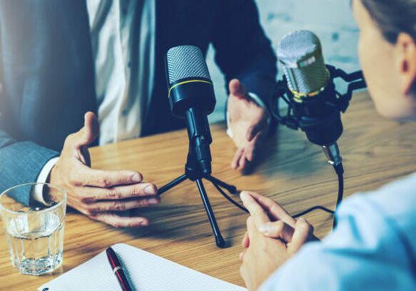 radio interview, podcast recording - business people talking in broadcasting studio